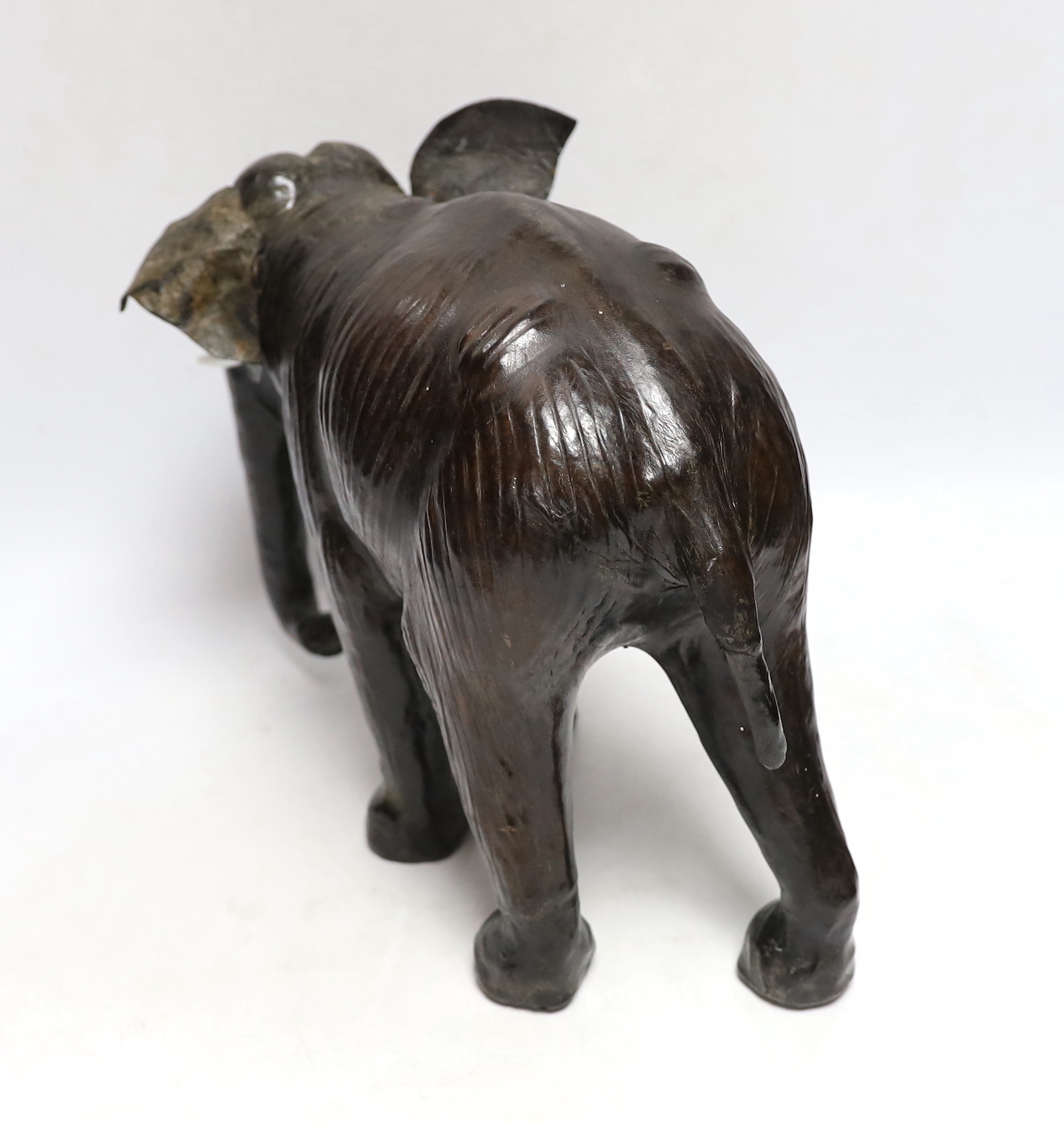 A leather elephant, stamped Liberty to the underside, 30cm wide